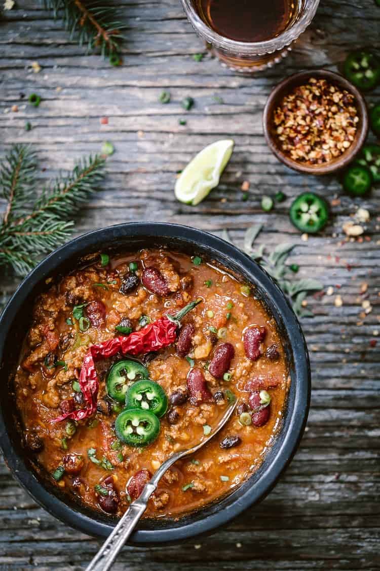 3 Bean Turkey Chili placed in a bowl and served with a spoon from the top view