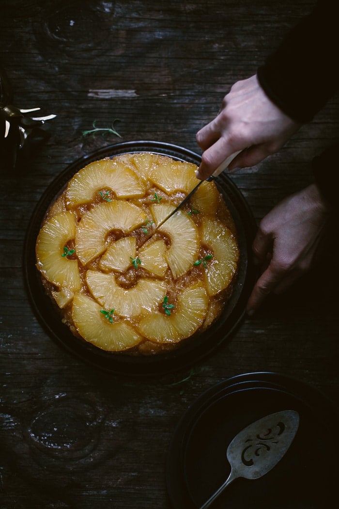 Person about to cut an Upside Down Pineapple Cake