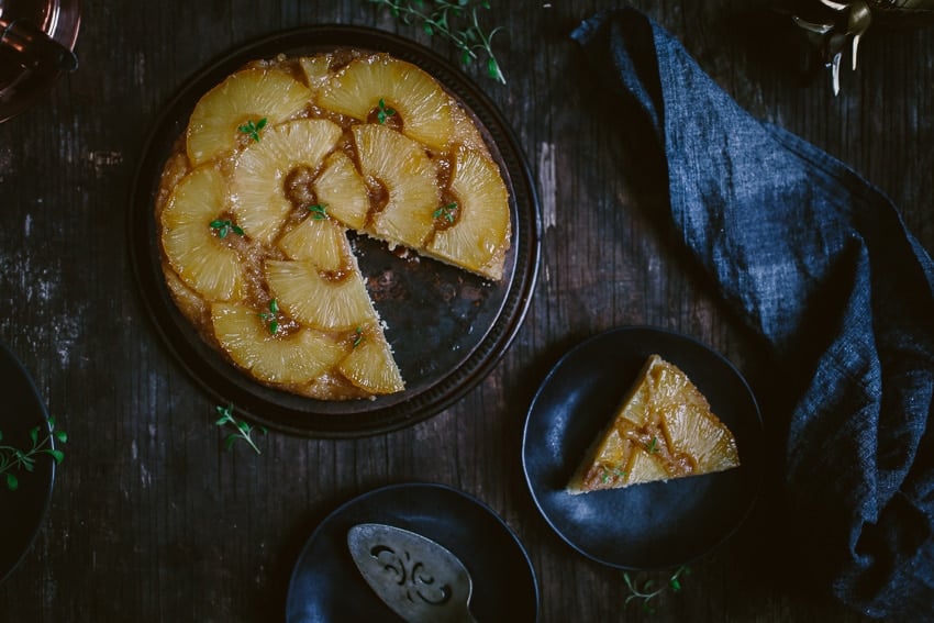 Overhead view of Upside Down Pineapple Cake with one slice removed and placed on a plate