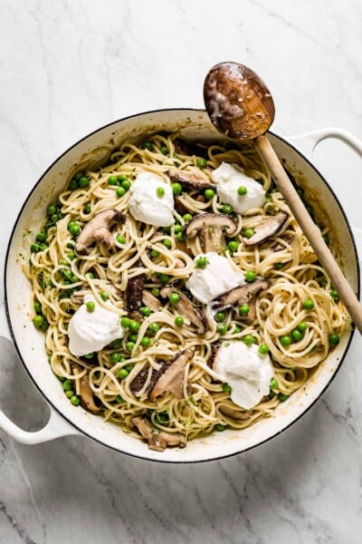 Pasta with Mushrooms and Peas in a large skillet garnished with ricotta cheese