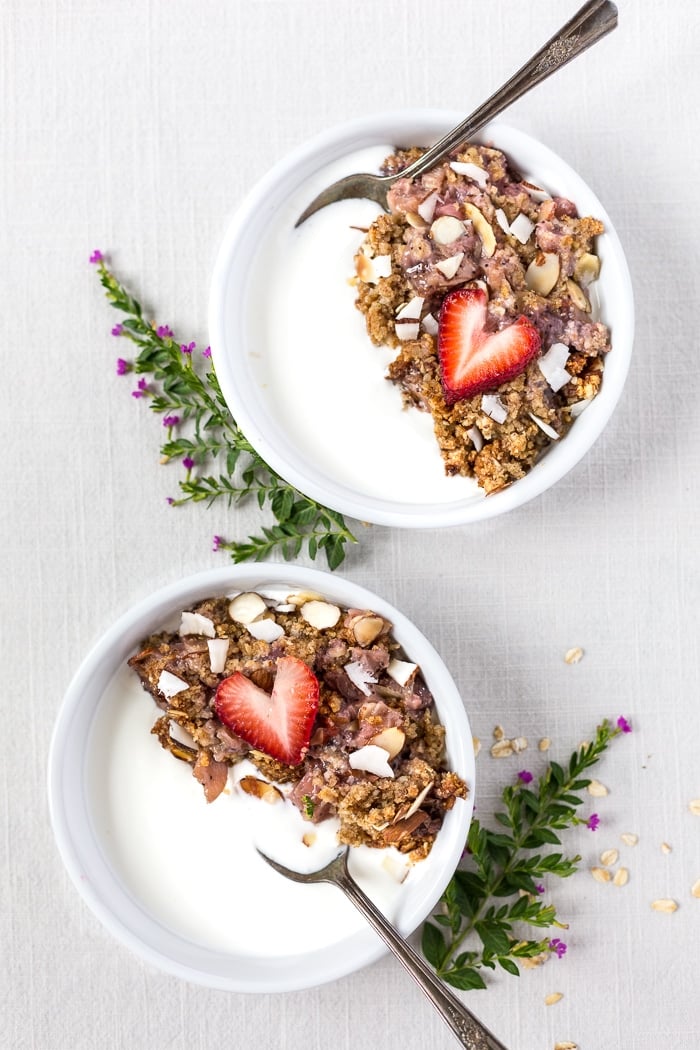 two bowls of healthy rhubarb breakfast garnished with strawberries