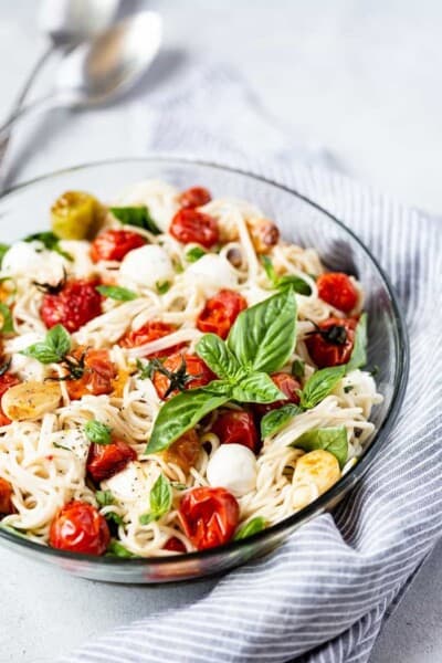 Caprese Pasta Salad Recipe placed in a large bowl garnished with basil