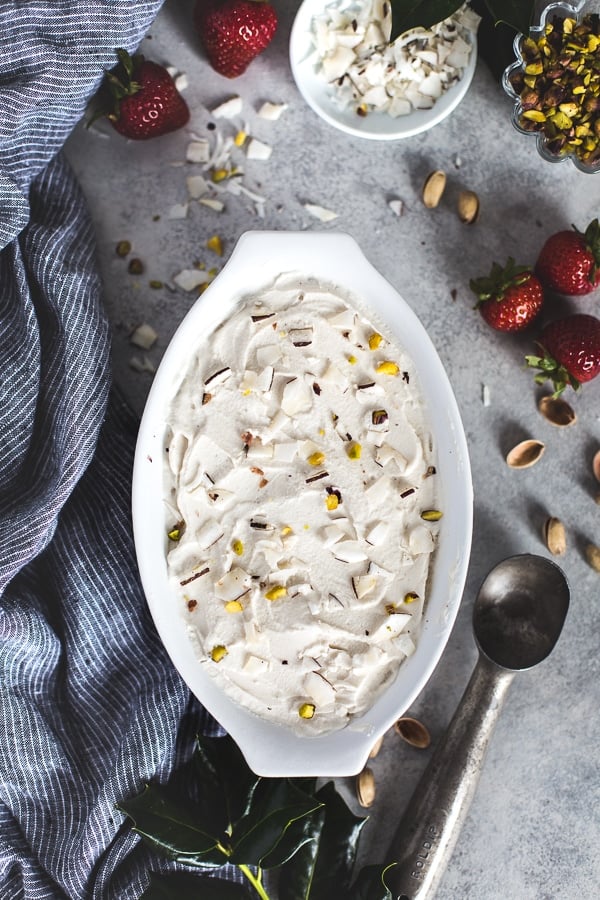 Cashew milk ice cream in a casserole dish with ice cream scoop on the side