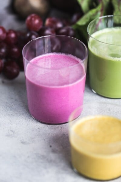 colorful beet smoothies in glasses from the front view