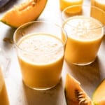 Cantaloupe smoothies in two glasses from the front view