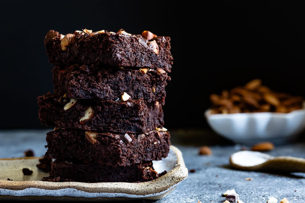 Vegan spelt flour brownies on top of each other from the front view.