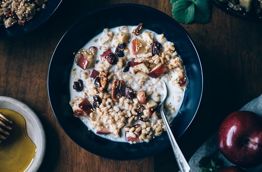 A bowl of farro breakfast mixed with almond milk