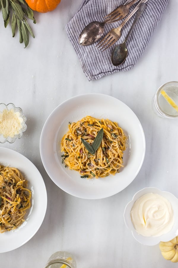 Overhead view of Pumpkin Creme Fraiche Pasta with Sage with ingredients for pumpkin sauce recipes