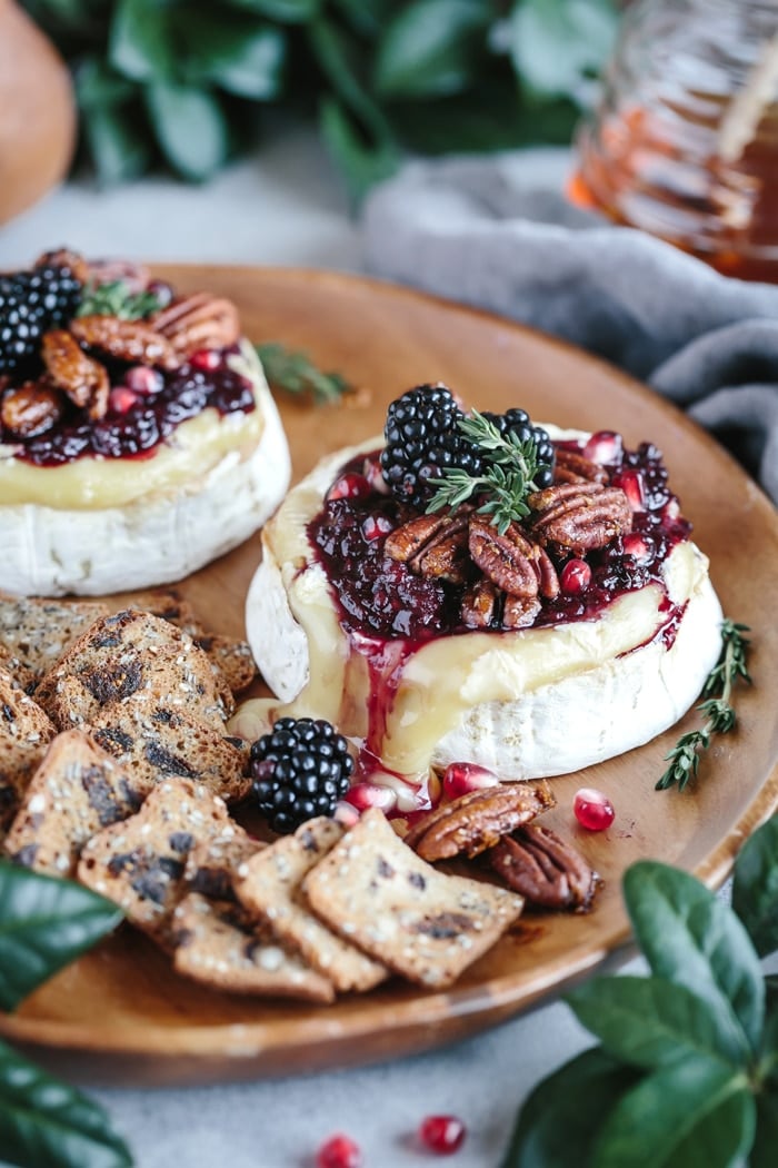 Baked Brie with Blackberry Compote and Spicy Candied Pecan on a plate