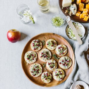 Cheesy Apple Bites with Walnuts, Celery, and Pomegranate Seeds: The easiest appetizer made with apple "crackers" topped off with cream cheese, walnuts, celery, and drizzled with honey.