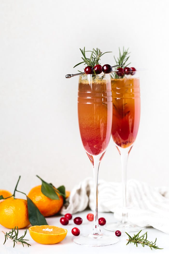 2 Clementine Cranberry Prosecco Cocktail with sliced and whole clementines and cranberries