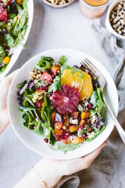 Citrusy Roasted Beet Goat Cheese salad with walnuts and black eyed peas ina bowl