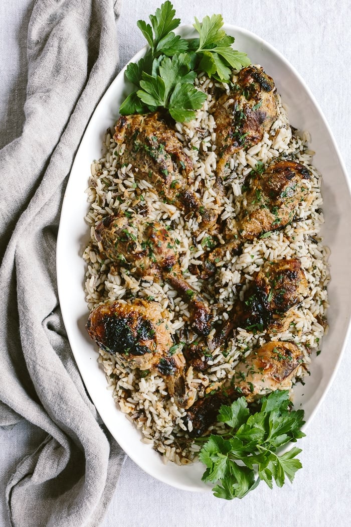 Slow Cooker Honey Mustard Drumsticks on a bed of rice in a platter: A delicious slow cooker honey-mustard chicken drumsticks recipe.