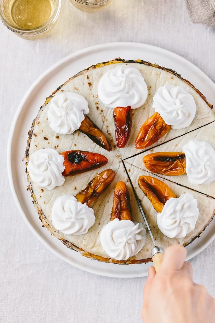 Overhead view of Chicken Quesadilla Cake being sliced with a knife