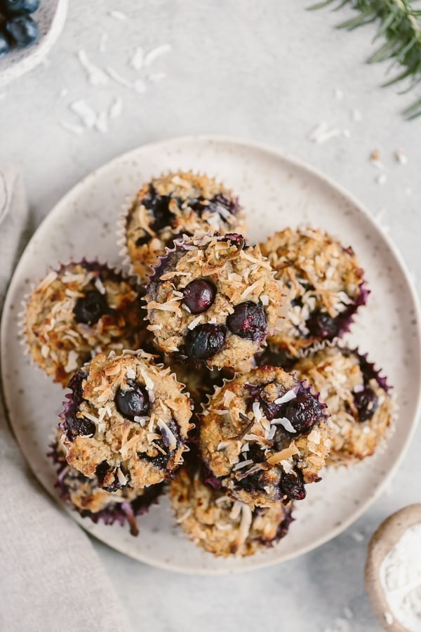 Almond flour coconut flour blueberry muffins on a plate from the top view.