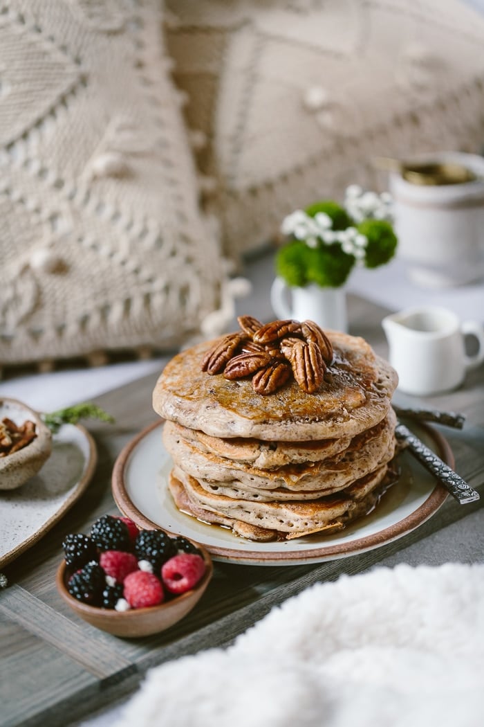 Buckwheat Pancakes Recipe on a bed setting with flours and tea in the background