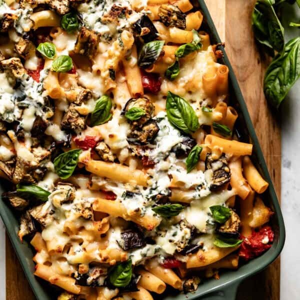 Eggplant baked ziti garnished with basil from the top view.