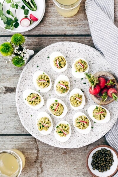 A plate filled with deviled eggs with mayo are photographed from the top view.