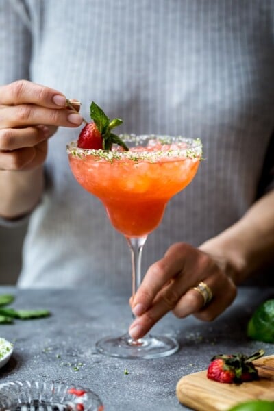 Strawberry Champagne Margaritas being served by a woman