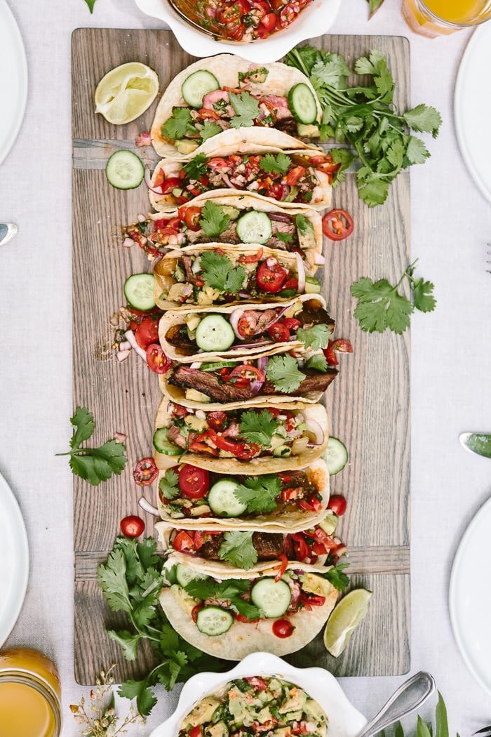 Flank steak tacos photographed on a cutting board - get the best beef taco marinade