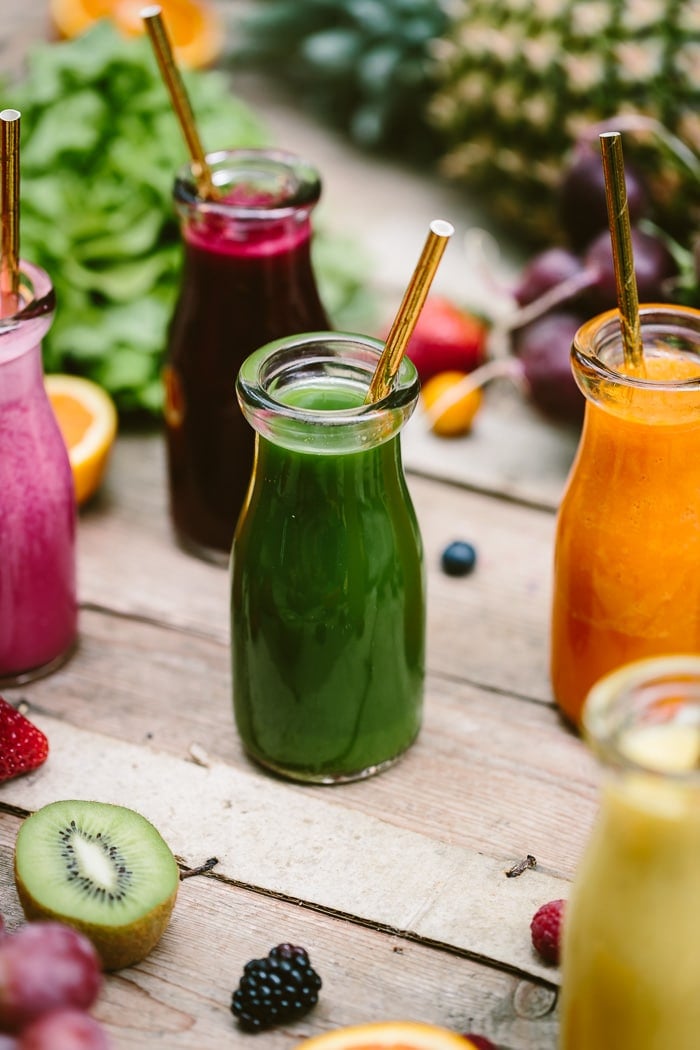 A bottle of green smoothie with a straw Benefits of Smoothies: Find out why it is good to have 1 smoothie a day. 