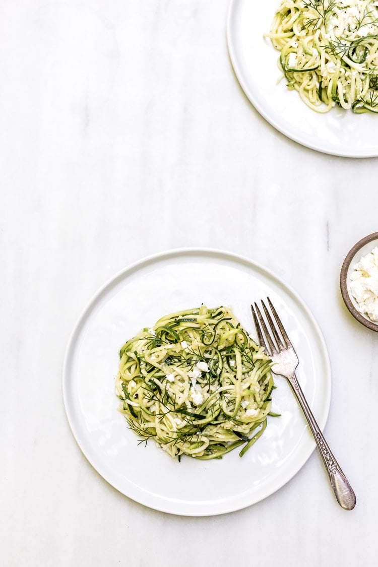 a plate full of 5-ingredient zucchini noodles is photographed from the top view.
