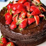 Almond flour chocolate cake garnished with strawberries on top