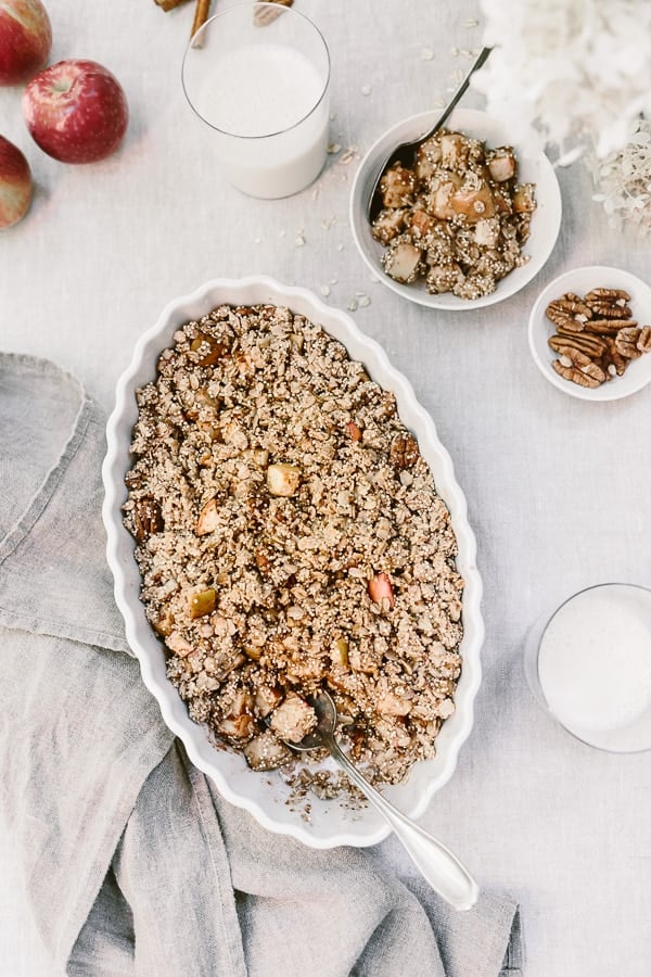 Healthy Crumble Recipe from the top view with a glass of milk and pecans on the side
