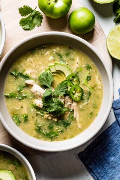 A bowl of Crockpot Chicken Tomatillo Soup Recipe served in a bowl with toppings