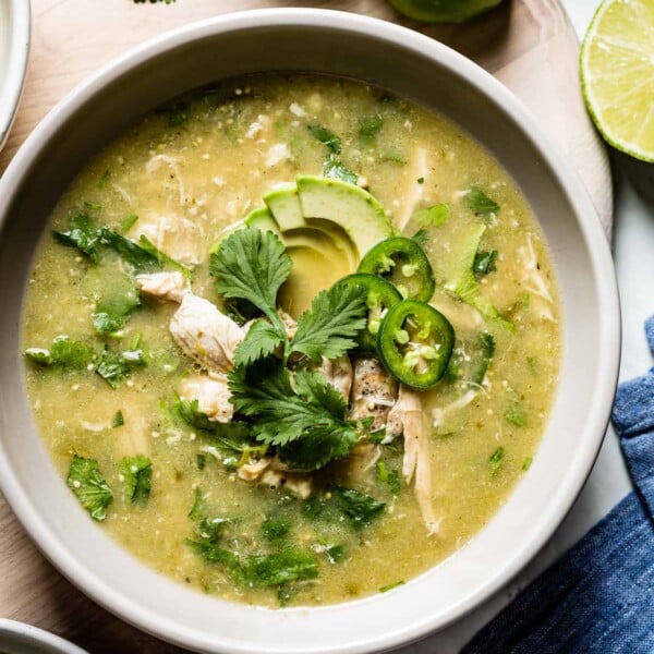A bowl of Crockpot Chicken Tomatillo Soup Recipe served in a bowl with toppings