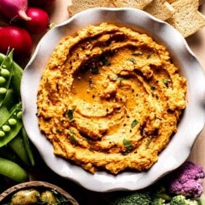 roasted carrot hummus in a bowl close up from the top view