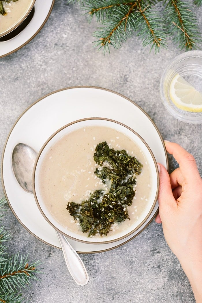 Sunchoke Soup: A heartwarming jerusalem artichoke (or sunchoke) soup served by a woman