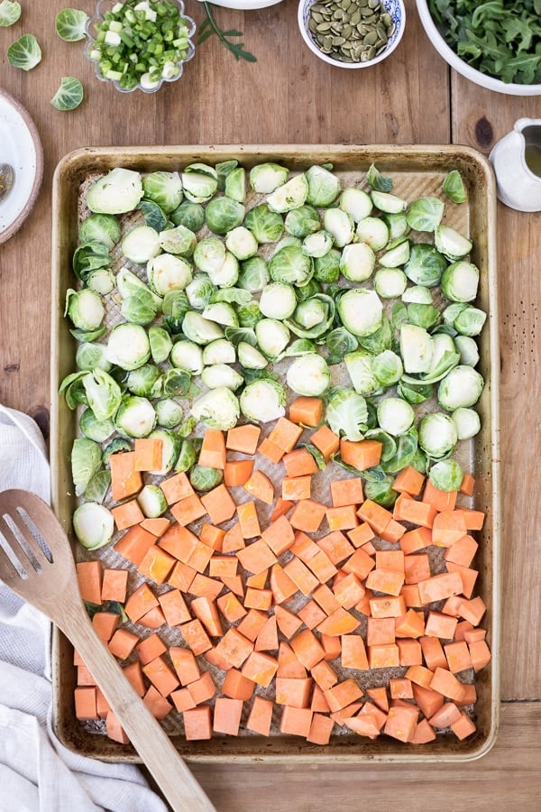 Roasted Brussels Sprouts and Sweet Potatoes - Roasted Brussels Sprouts and Sweet Potatoes drizzled with olive oil and sprinkled with salt and pepper. Spread out on a baking sheet.