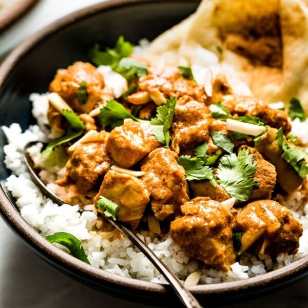 Slow Cooker Butter Chicken placed in a bowl over basmati rice