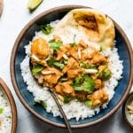 Slow Cooker Butter chicken over basmati rice and naan in a bowl
