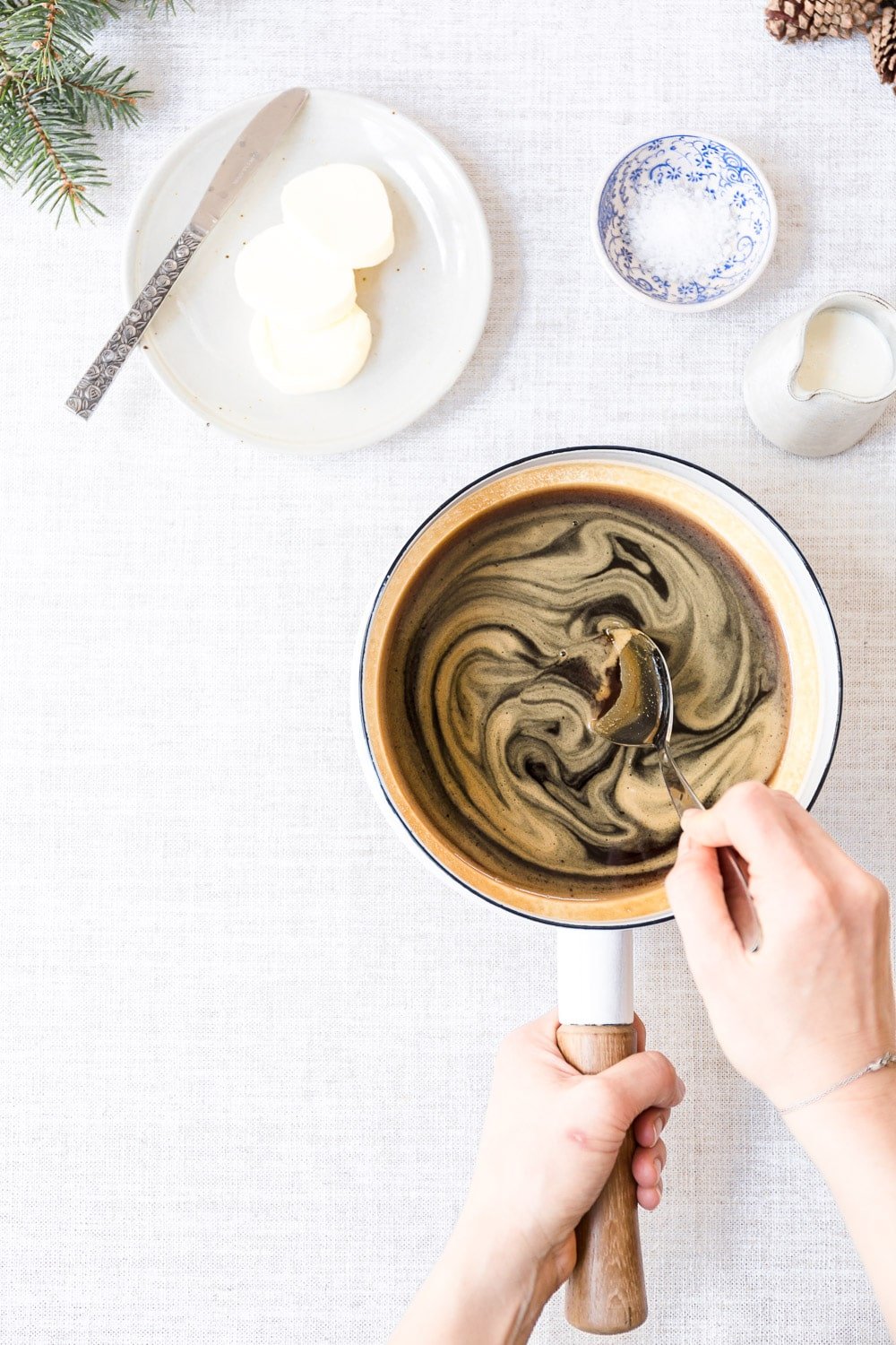 A woman is photographed as she is making caramel for caramel nut tart.