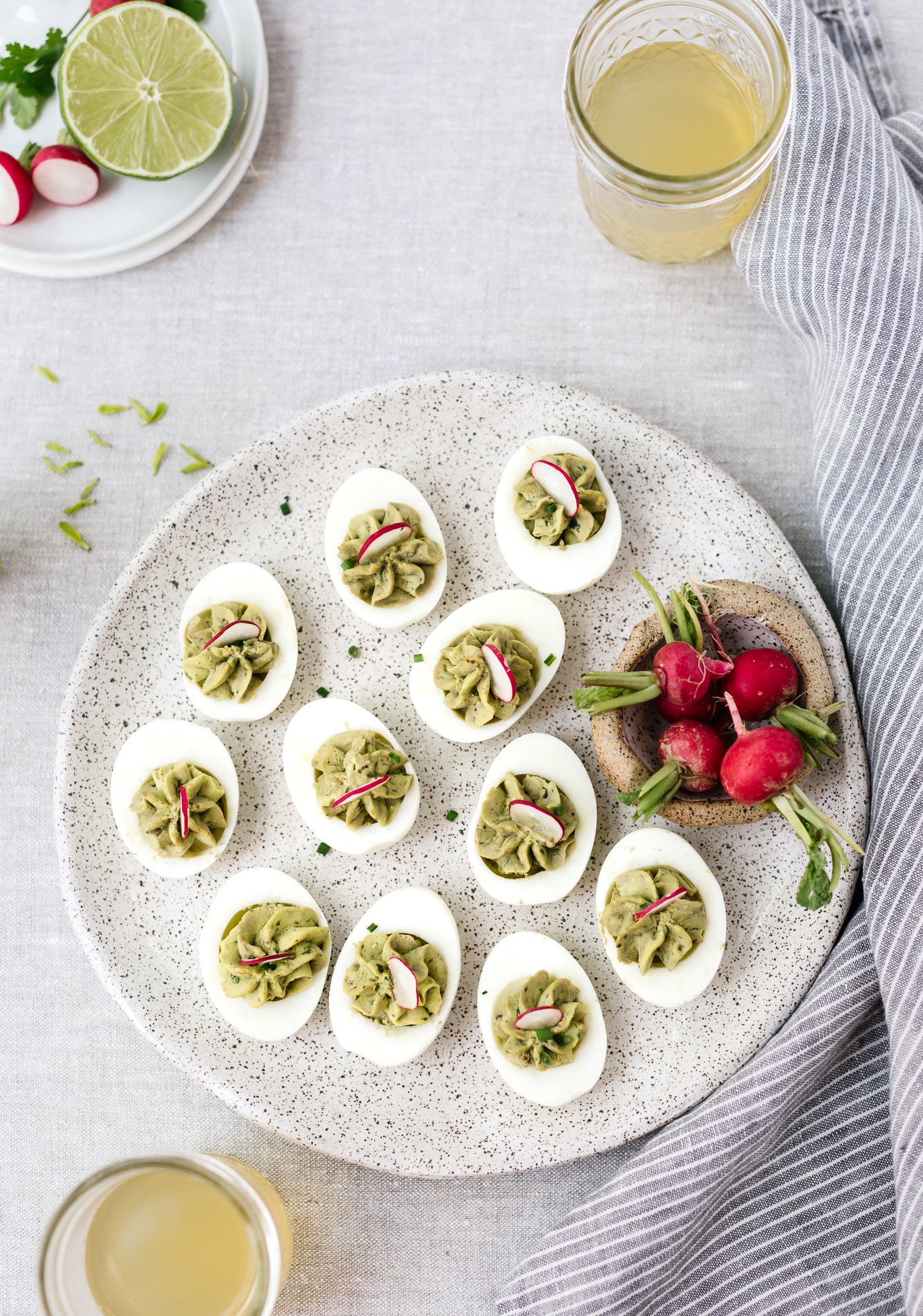 Avocado Deviled Eggs garnished with radishes photographed from the top view.