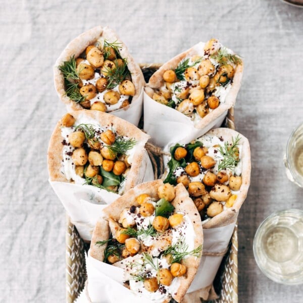 Roasted Chicken Pita Wrap with Crispy Chickpeas and Tzatziki are placed in a basket and photographed from the top view.