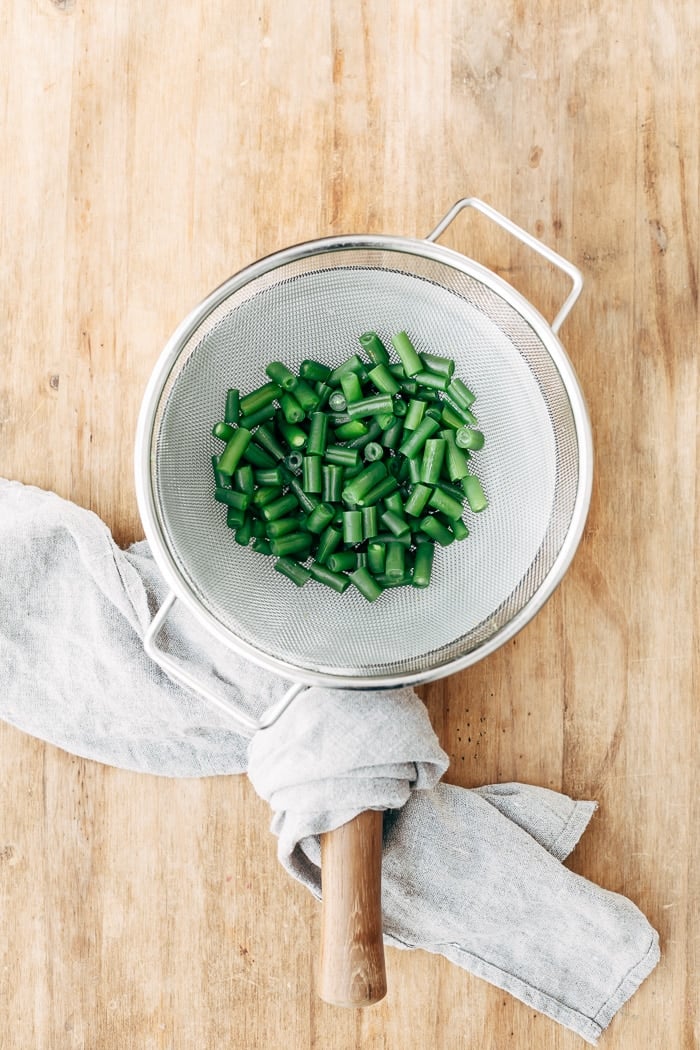 5 Bean Salad - Freshly cooked green beans are placed in a colander to drain before they go into the five bean salad. 