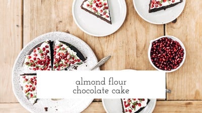 A sliced Naturally sweetened almond flour chocolate cake with several slices is photographed from the top view.