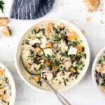 Three bowls of Lightened-Up Creamy Chicken and Wild Rice Soup are photographed from the top view.