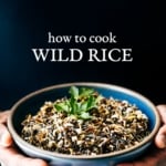 A man is photographed from the front view (close up) with a bowl of cooked wild rice garnished with a few leaves of parsley for the How To Make Wild Rice Recipe post.