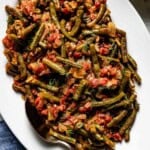Turkish green beans on a plate garnished with dill.