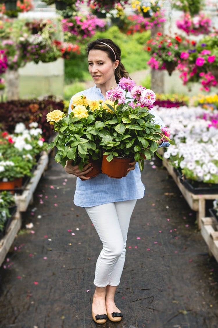 What I know for sure - A woman photographed from the front view with flowers in her hands.