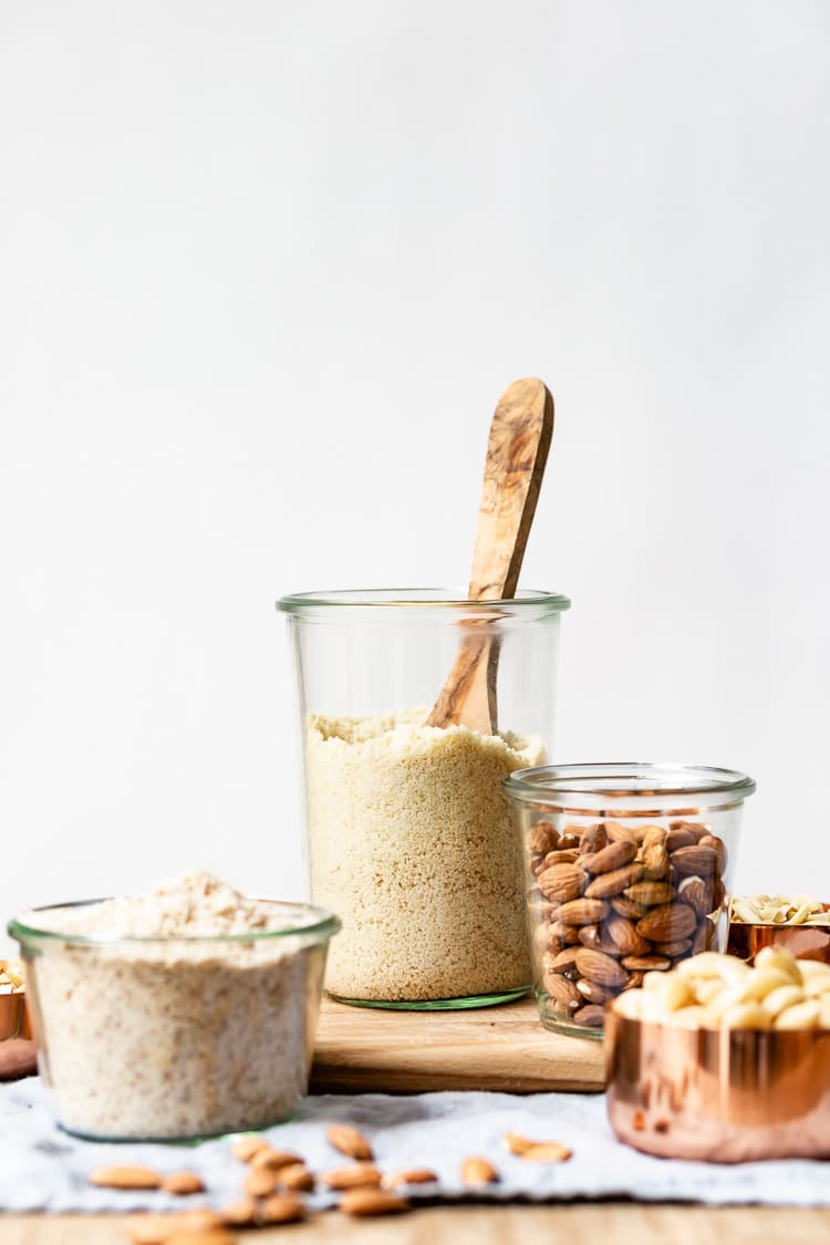 Almond flour and almond meal in small containers from the front view.