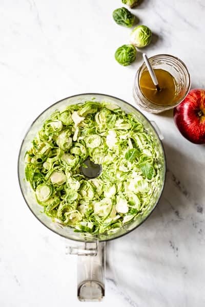 Shredded brussel sprouts in food processor bowl - Learn how to shave brussel sprouts.