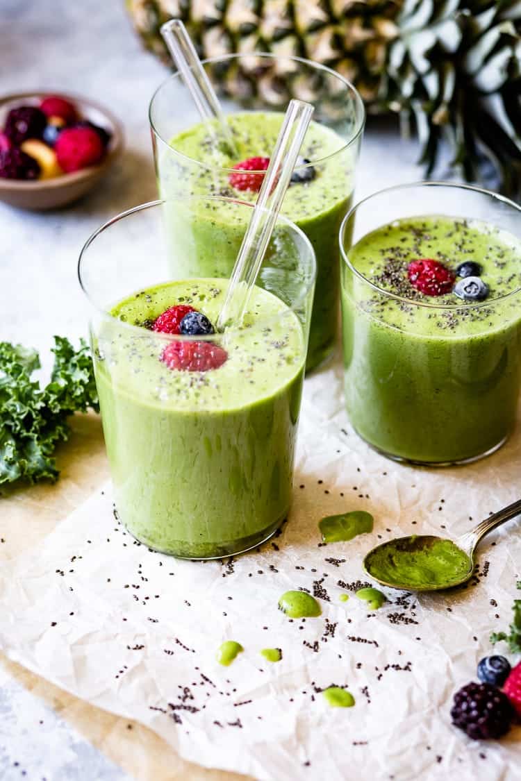 Kale smoothies decorated with berries.