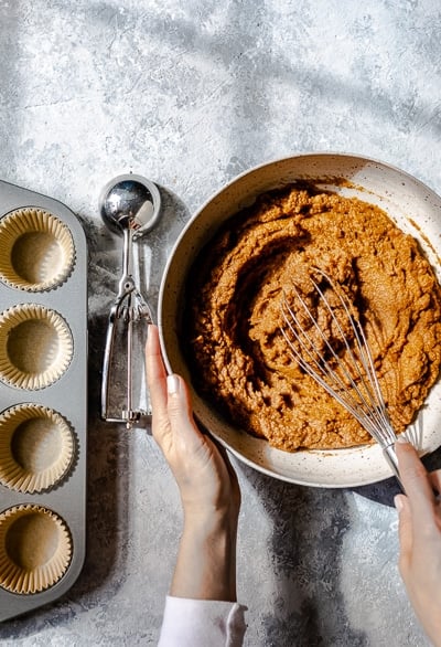 Mixing healthy pumpkin muffins with almond flour