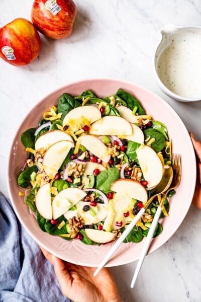 Apple Salad Recipe Healthy served in a bowl by a woman