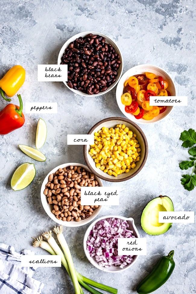 ingredients - black beans, tomatoes, peppers, corn, black eyed peas, avocado, red onion and scallions.